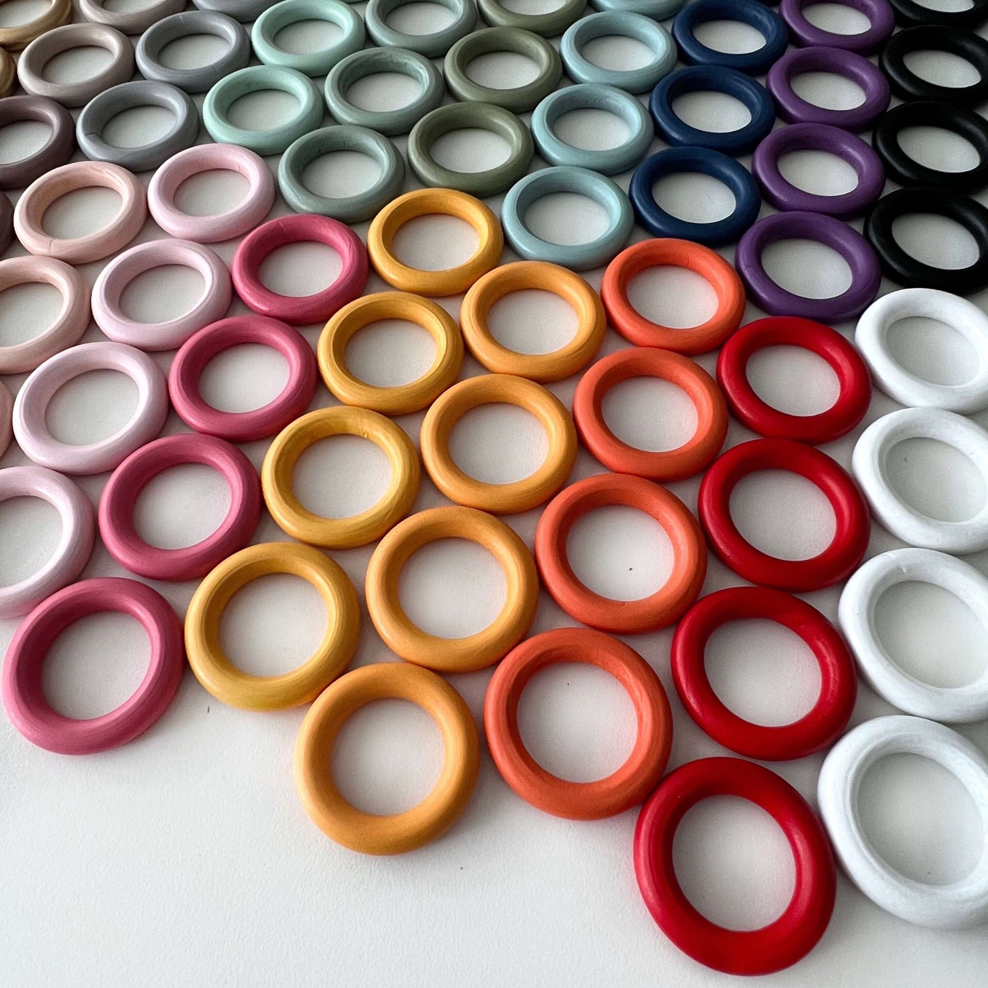 coloured wooden beads scattered on white desk