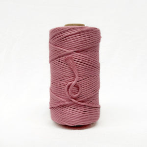 deep pink macrame cotton string photo on white wall