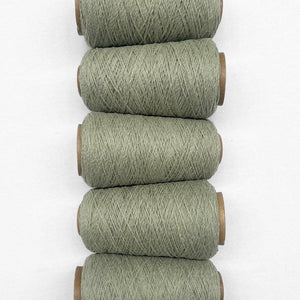 5 rolls of sage green wool rope laying side by side in flat lay image on white background 