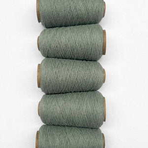 5 rolls of eucalyptus green woolen crod flaying side by side on white backdrop showing up close details 