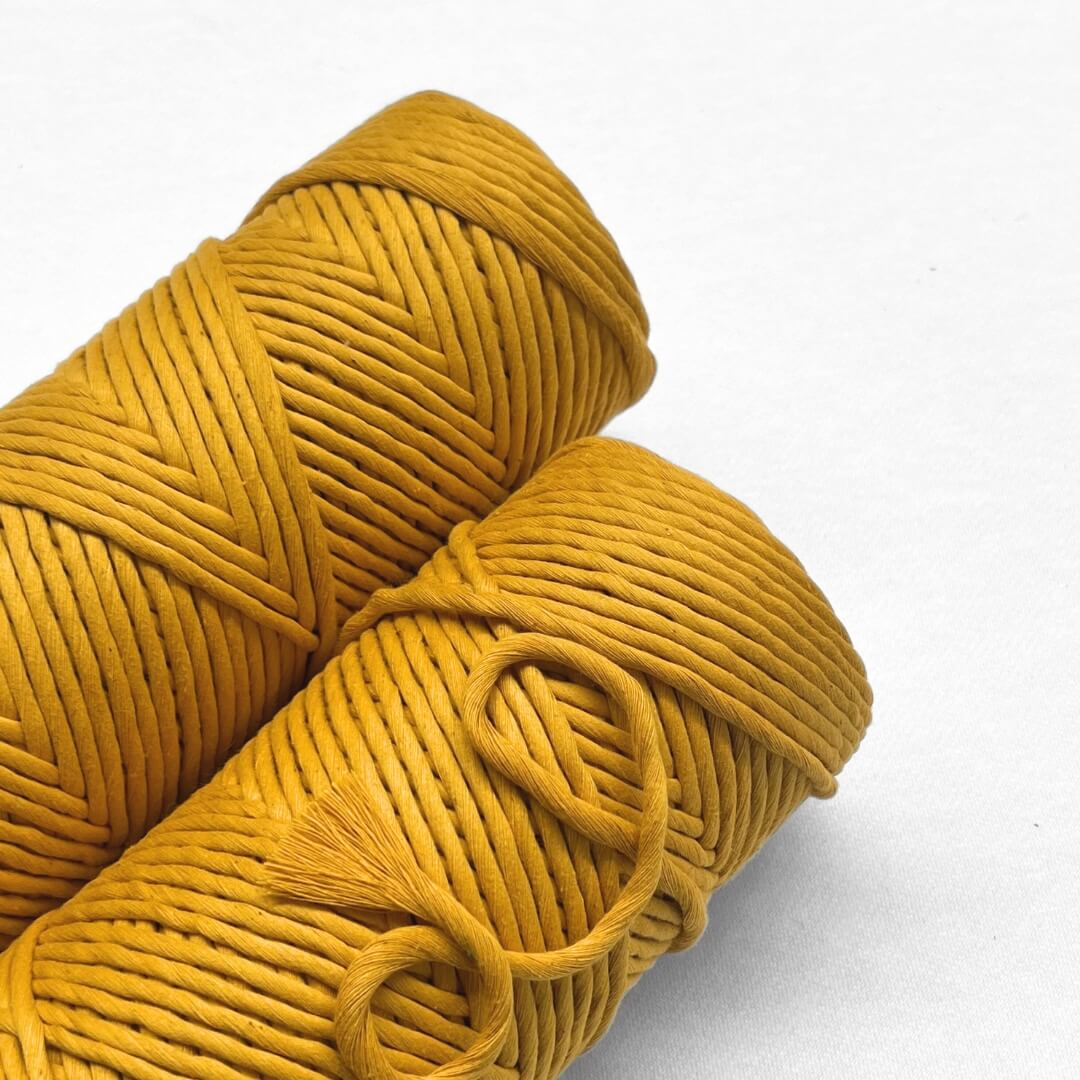 7b two rolls of marigold yellow laying flat on white background close up image showing buttery sheen